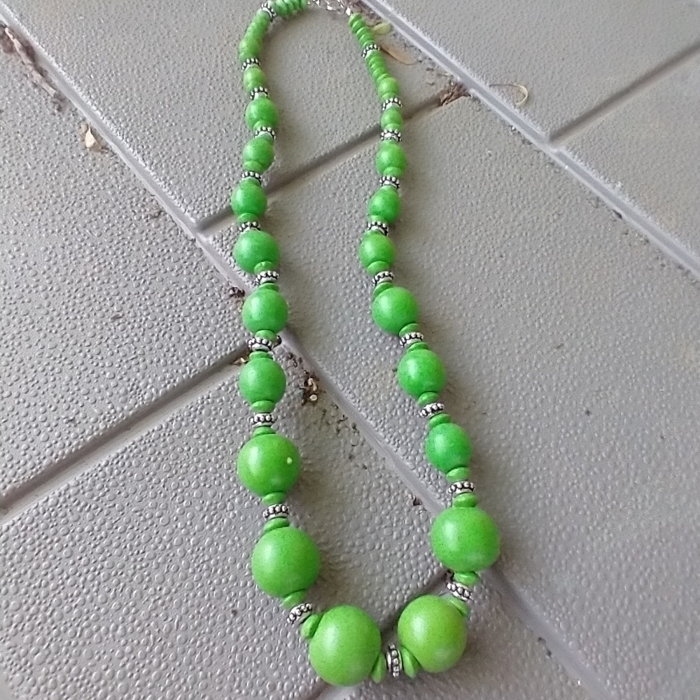 Women's bright green wooden bead necklace.